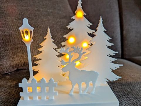 Cenário iluminado com rena impresso em 3D